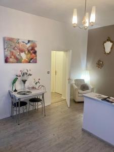 a living room with a table and a couch at Albi-Suite in Albi