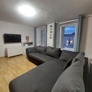 a living room with a couch and a large window at Ellipse apartment in Piran