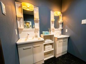 a bathroom with two sinks and a large mirror at A-GATE Hotel Hakodate in Hakodate +20 photos
