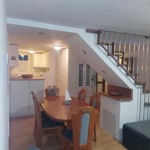 a kitchen and dining room with a table and a staircase at Ellipse apartment in Piran
