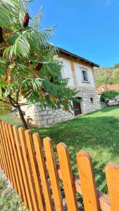 a wooden bench sitting in front of a house at Seosko domaćinstvo Rada in Papratište +6 photos