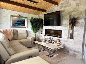 a living room with a couch and a table at Danu Escape in Gneevgullia