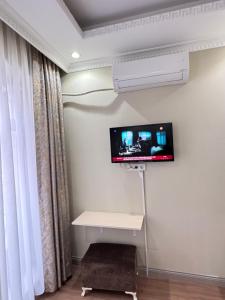 a room with a flat screen tv on the wall at RENOVA hOTEL FATİH in Istanbul