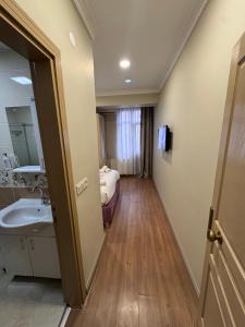 a bathroom with a sink and a bed in a room at RENOVA hOTEL FATİH in Istanbul +16 photos