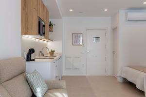a living room with a couch and a kitchen at Apartamentos Armonia Peñíscola in Peniscola