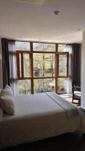 a bedroom with a large bed and a large window at Aguas de Ibias in Cecos
