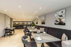 a restaurant with tables and chairs and a couch at Zalel Hotels Laleli in Istanbul