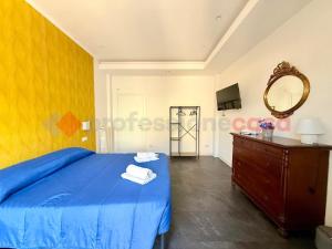 a bedroom with a blue bed and a mirror at Attico vista mare in Gaeta