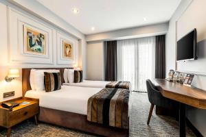 a hotel room with a bed and a desk at Zalel Hotels Laleli in Istanbul +54 photos