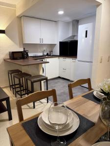 a kitchen and dining room with a table and chairs at Hotel lázaro in Calamocha