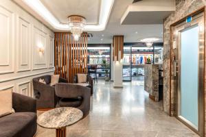 a lobby with couches and chairs and a table at Zalel Hotels Laleli in Istanbul