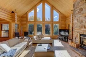 a large living room with a large stone fireplace at Fiddler Lake Resort - Deer 59 in Mille-Isles