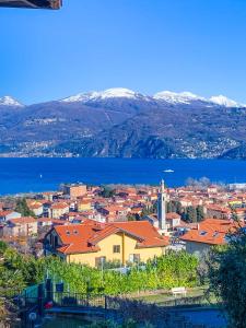a view of a city and the water and mountains at Casa Lago in Germignaga
