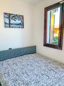 a bedroom with a bed and a mirror on the wall at Casa Lago in Germignaga +23 photos