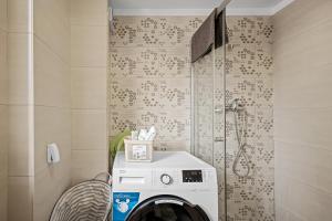 a washing machine in a bathroom with a shower at FLH - Cozy Heaven in Chiajna