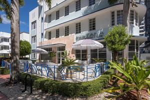 a building with a table and umbrella in front of it at Pestana South Beach Miami in Miami Beach