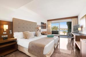 a bedroom with a large bed and a television at VIVA Golf Adults Only 18+ in Port d'Alcudia