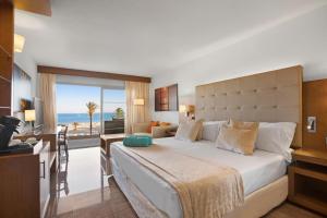 a hotel room with a bed and a desk with a view at VIVA Golf Adults Only 18+ in Port d'Alcudia