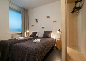 a bedroom with two beds with towels on them at Forenom Hostel Jyväskylä in Jyväskylä