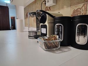 a counter with a coffee maker and a basket of matches at Villa Bazzera in Mestre +15 photos