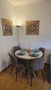 a dining room table with chairs and a table and a table at La Casa di Draf Appartamento Humanitas IEO Forum in Rozzano