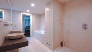 a bathroom with a sink and a bath tub at Villa Regina in Sala Comacina +11 photos