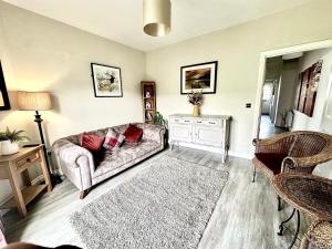 a living room with a couch and a rug at Newcastle Pet friendly 1 bed drive garden 10m city in Kenton