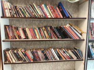 a book shelf filled with lots of books at Green bell male dormitory in Bhopal