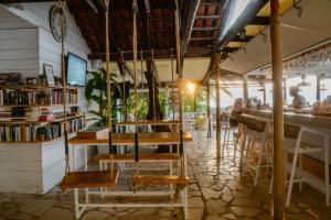 a bar with wooden tables and chairs in a restaurant at Metaxatos Apartments in Lassi