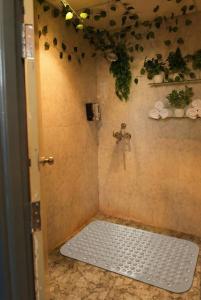 a bathroom with a shower with a tile floor at Spectrum Mall 1BHK Balcony Suite in Noida