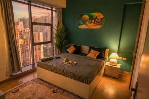 a bedroom with a bed and a large window at Spectrum Mall 1BHK Balcony Suite in Noida