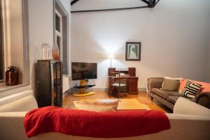 a living room with a couch and a tv at High living @ Ferguson Court in Carlisle +64 photos