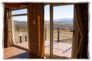 an open door with a view of the mountains at De Ark Mountain Lodge in Clarens +27 photos