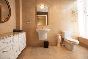 a bathroom with a sink toilet and a mirror at INASS in Sitges
