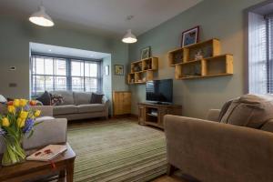 a living room with a couch and a tv at Tangle Tower in Inverness