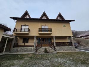 a house with two balconies on the front of it at Vila dintre Brazi in Moieciu de Jos