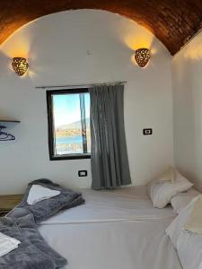 a bedroom with two beds and a window at Turia Hotel in Aswan