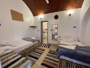 a room with two beds and a mirror at Turia Hotel in Aswan