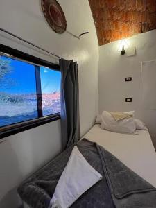 a small room with a bed and a window at Turia Hotel in Aswan +2 photos