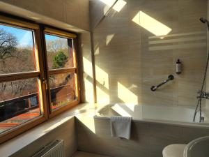 a bathroom with a tub and a sink and a window at Dom Oliwski in Gdańsk +65 photos