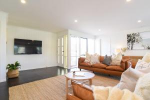a living room with a couch and a table at The Salt Shack in Mallacoota