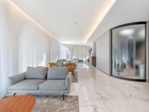 a living room with a couch and a table at B&B HOTEL Habitat Giussano in Giussano +30 photos