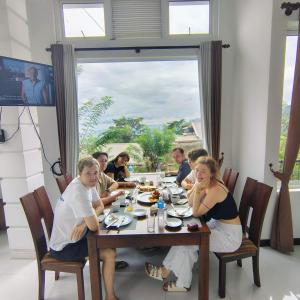 a group of people sitting around a table eating at Kandy Alpine Breeze in Kandy +28 photos
