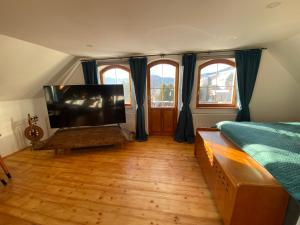 a bedroom with a bed and a flat screen tv at Hunters Lodge in Liptovská Lúžna