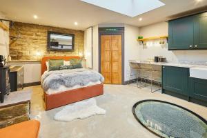 a large bedroom with a bed and a kitchen at The Churchside Well in Ravenscar