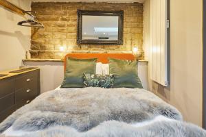 a bedroom with a bed with a mirror on the wall at The Churchside Well in Ravenscar