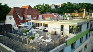 a balcony with tables and chairs on a building at Hotel Krone ****S in Tübingen