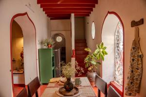 a dining room with a table and a green refrigerator at Luxury 3BHK Pool Villa Near Beach Pondicherry in Pondicherry