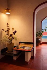 a room with a table with a vase with flowers on it at Luxury 3BHK Pool Villa Near Beach Pondicherry in Pondicherry