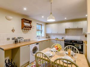 a kitchen with a table and chairs and a sink at 2 Bed in York oc-91049 in Kirkbymoorside
